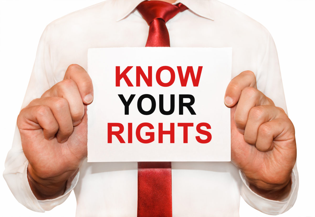 Man holding a card with a text Know Your Rights