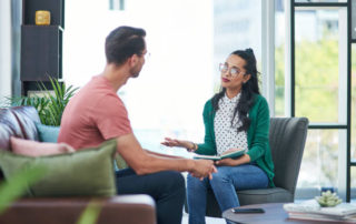 Shot of a young man and woman having a discussion in a modern office
