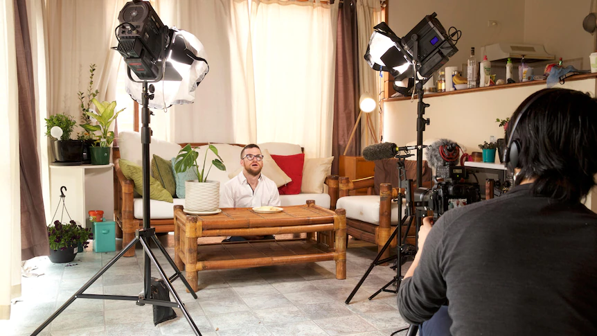 Young man being interviewed in a home